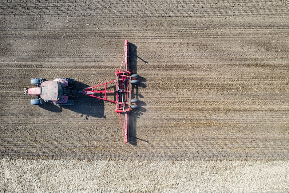 Drone shot of a tractor plowing a field in rural Plainview, Minnesota.